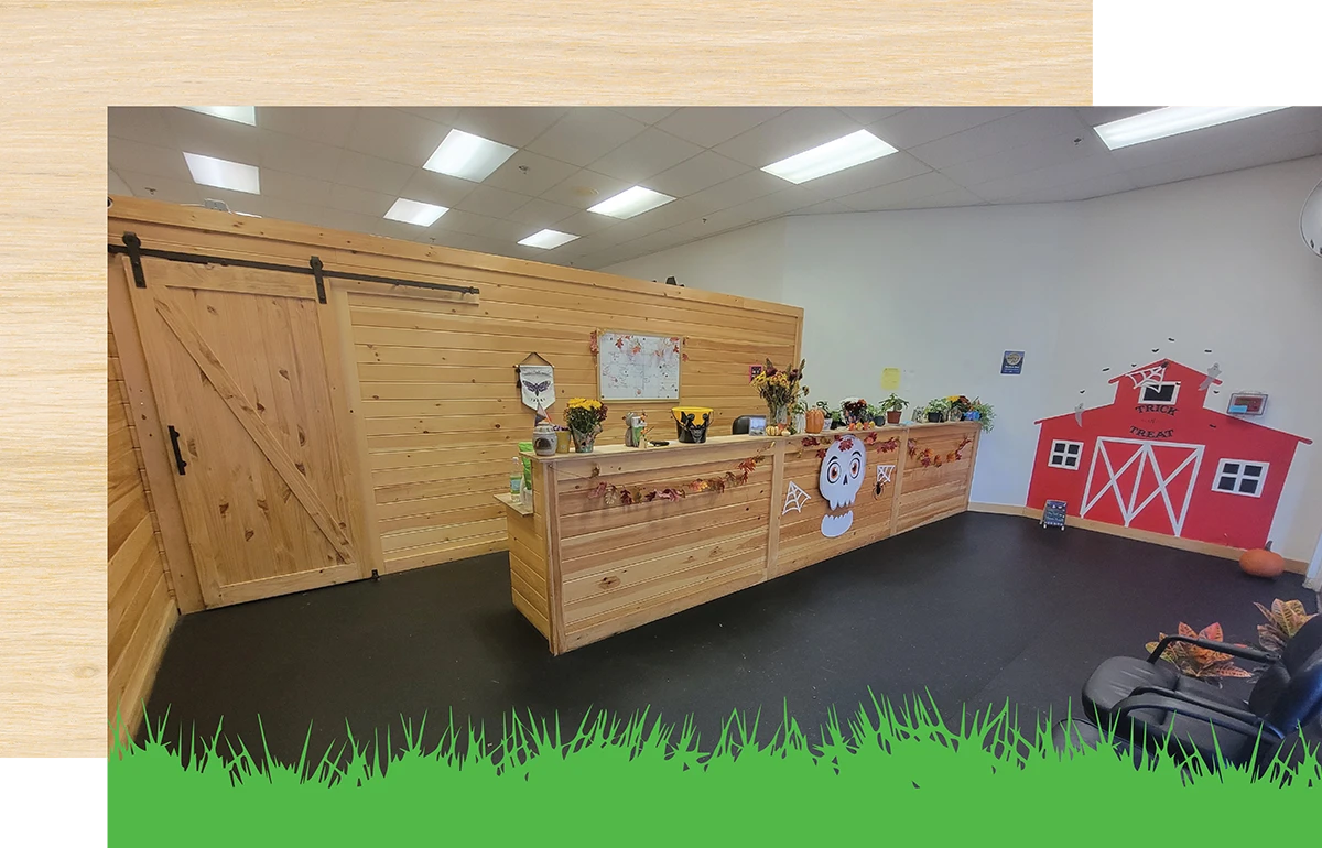 Rustic reception area with a wooden desk and barn-themed decor.