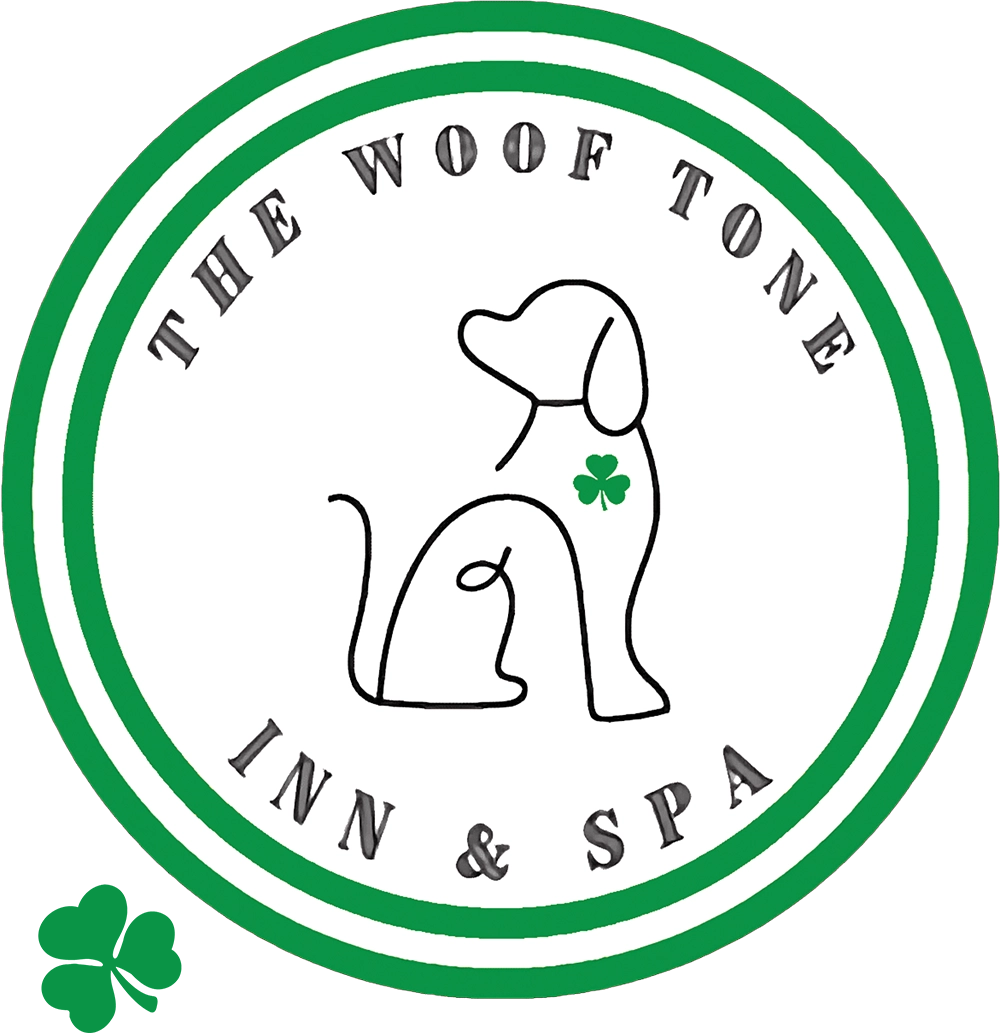 Logo for The Woof Tone Inn & Spa featuring a line-art dog with a green shamrock and a circular green border.